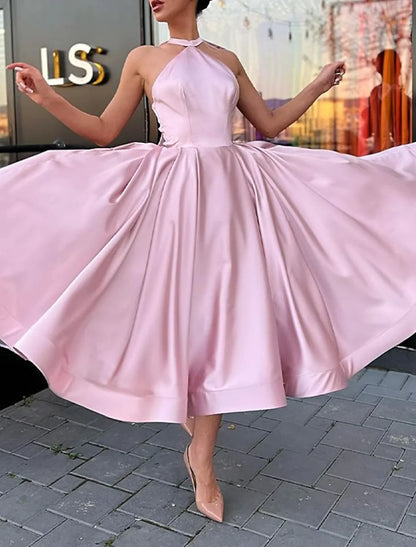 Plus size model wearing an elegant A-line halter satin dress with butterfly detail.