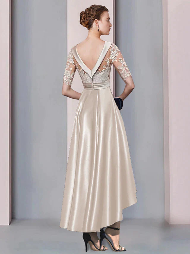 Close-up of the elegant A-line mother of the bride dress, showing the scoop neck, half sleeves, and delicate lace appliques.