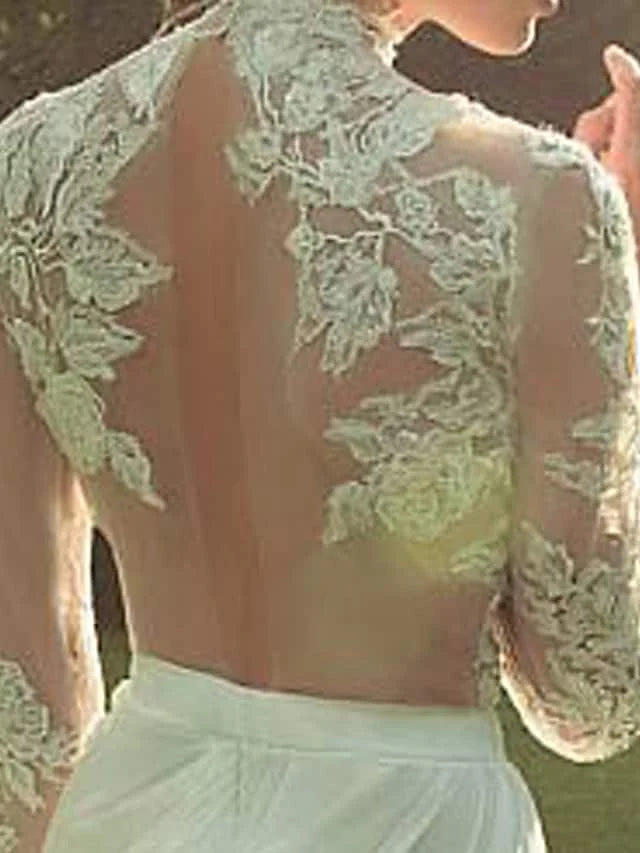 Back view of wedding dress, highlighting court train and lace appliques.