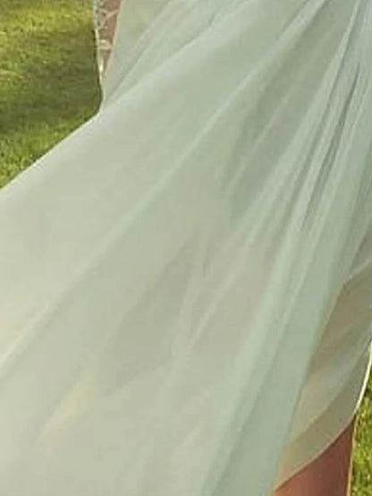 Detail of the split front and lace fabric on the A-line bridal gown.