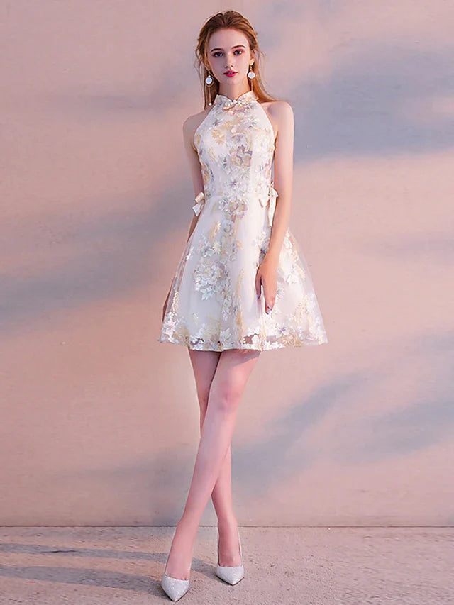 Model wearing a two-piece A-line high neck long sleeve floral embroidered mini cocktail dress, side view.