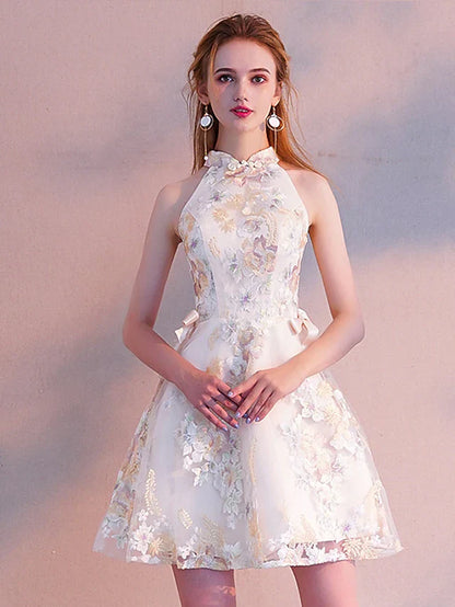 Model wearing a two-piece A-line high neck long sleeve floral embroidered mini cocktail dress, back view.