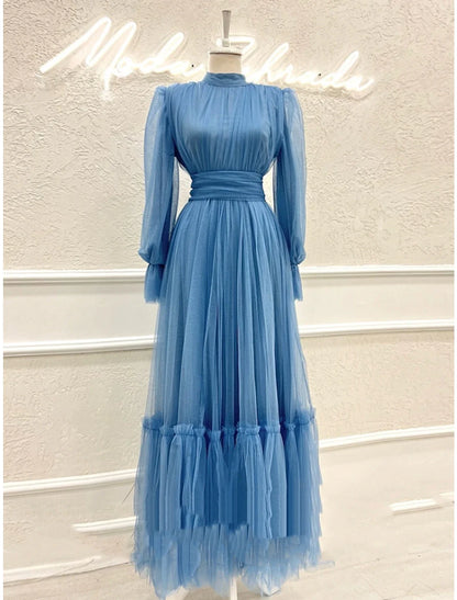 Close-up of the high neck and long sleeve details on an A-line tulle dress.