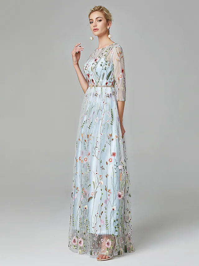 Elegant A-Line evening gown with illusion neck, 3/4 sleeves, lace, and embroidery.