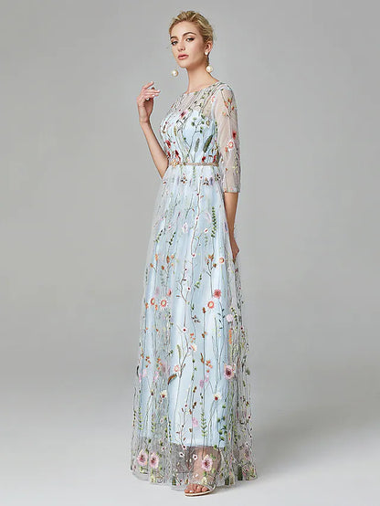 Elegant A-Line evening gown with illusion neck, 3/4 sleeves, lace, and embroidery.