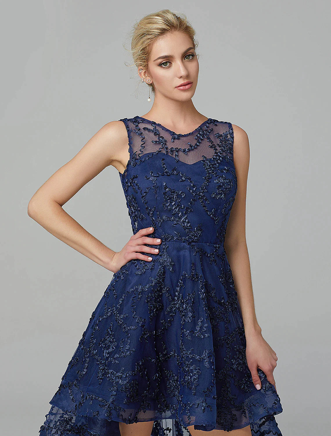 Close-up of the illusion neckline and intricate appliques on the multi-color tulle dress.