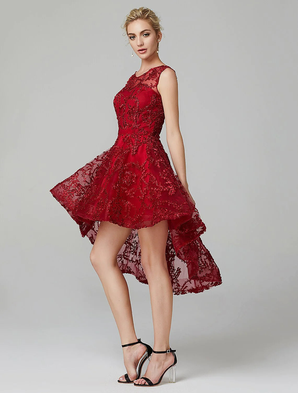 Model walking, showing the flow of the multi-color A-line tulle dress with asymmetrical hem.