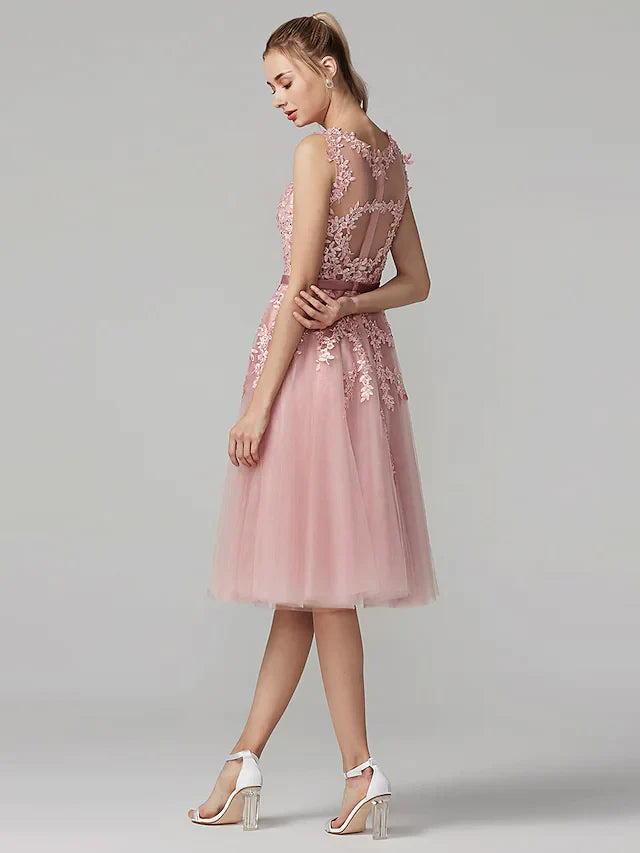 Model in A-line floral beaded cocktail dress, side view, showing illusion neckline.