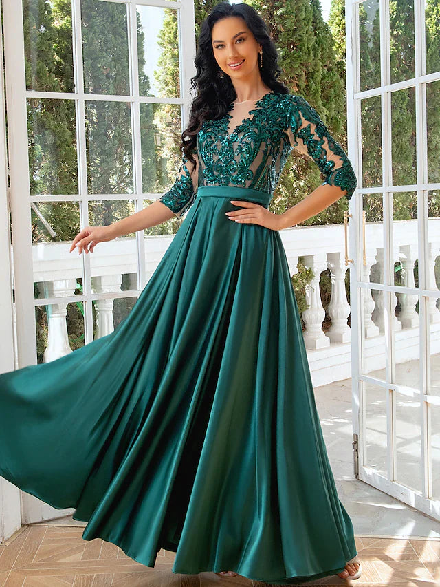 Elegant A-line evening gown with illusion neck and sequin slit.