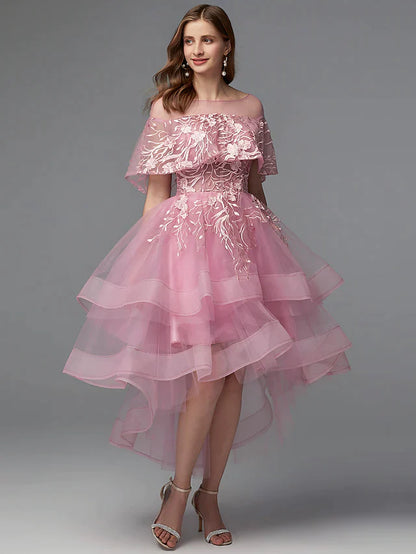 Model wearing a dark A-line high-low dress with illusion neck and lace details.