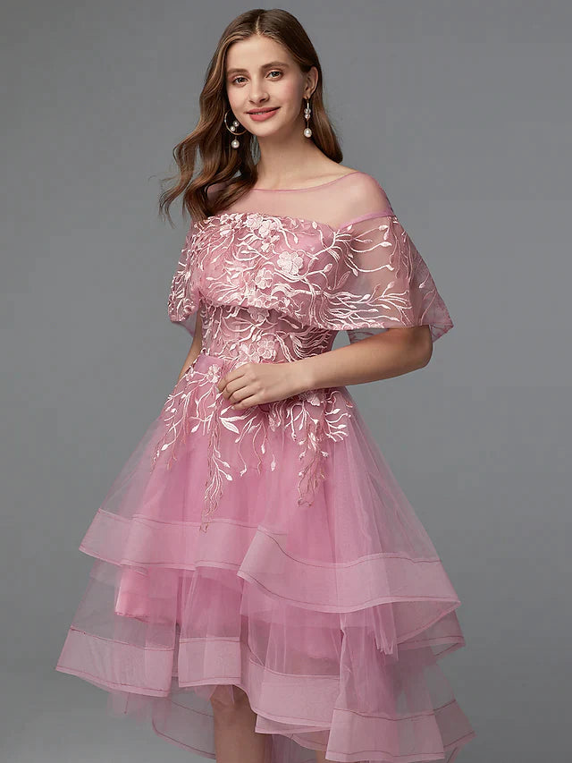 Back view of the dark A-line dress, showing asymmetrical hem and lace.