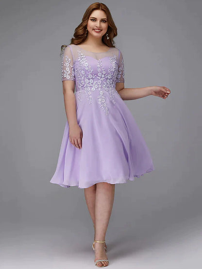 Back view of a navy plus size chiffon and lace cocktail dress.