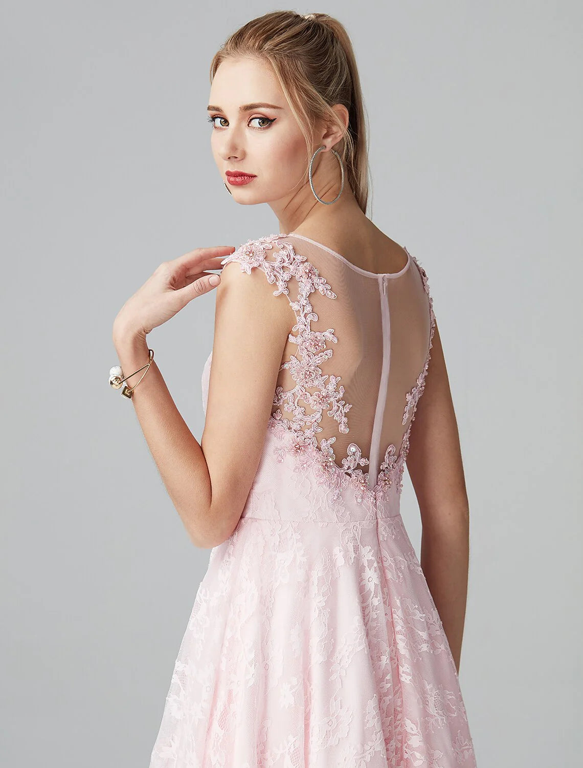 Side profile of a model wearing the navy blue A-line floral lace dress.