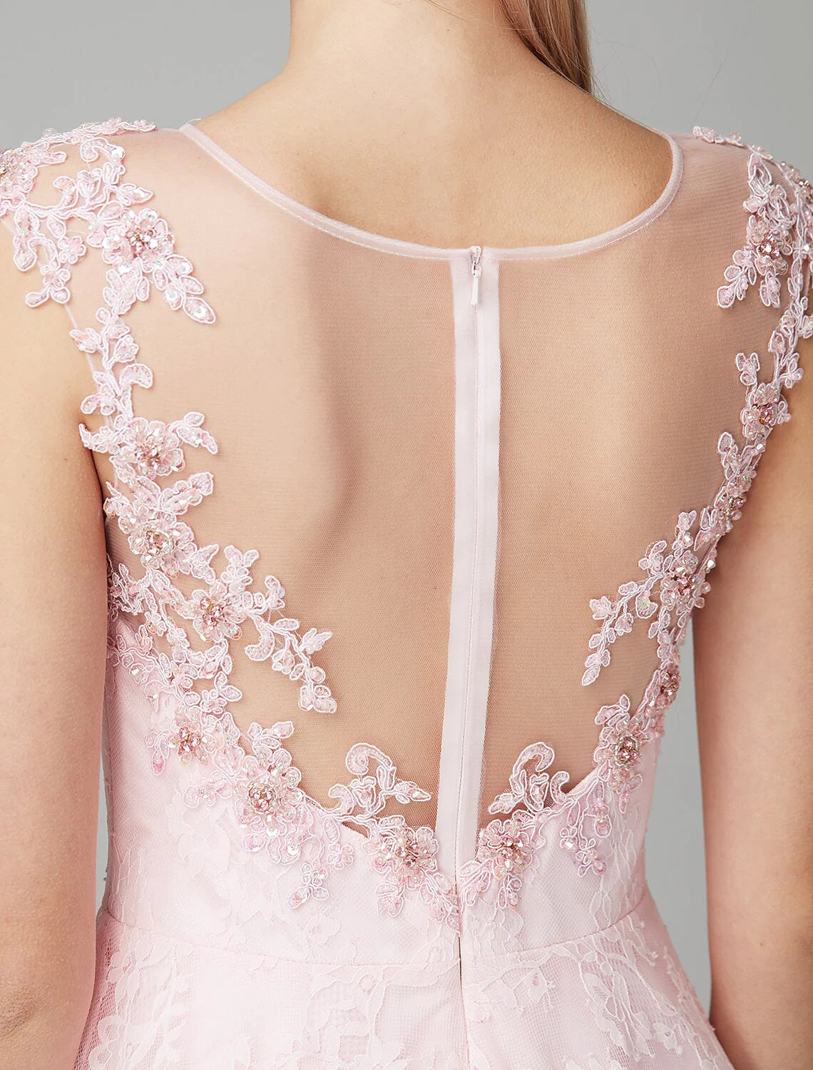 Detail of the floral lace appliques and short sleeves on the navy blue dress.