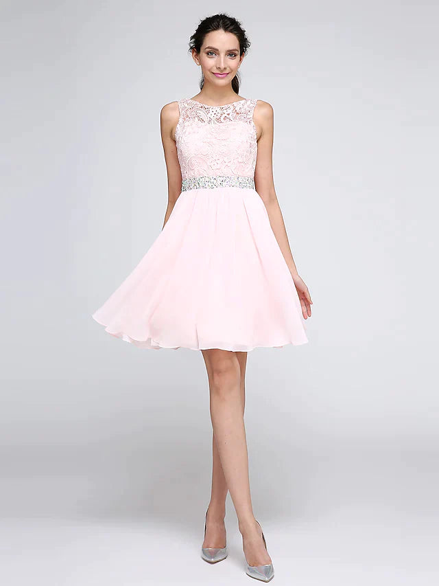 Woman wearing an A-line illusion neck mini cocktail dress with lace and crystal details.