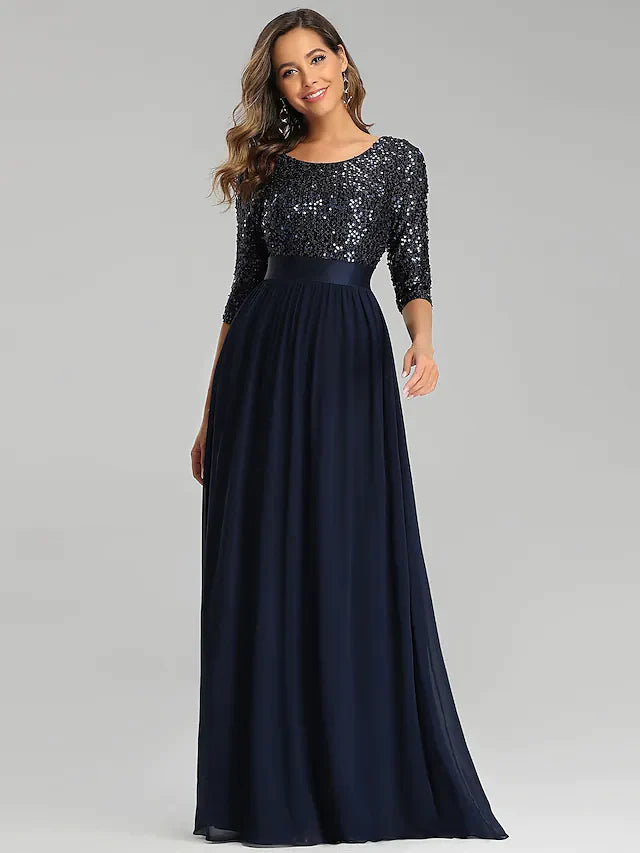 Elegant A-line sequined tulle evening gown with jewel neck and 3/4 sleeves.