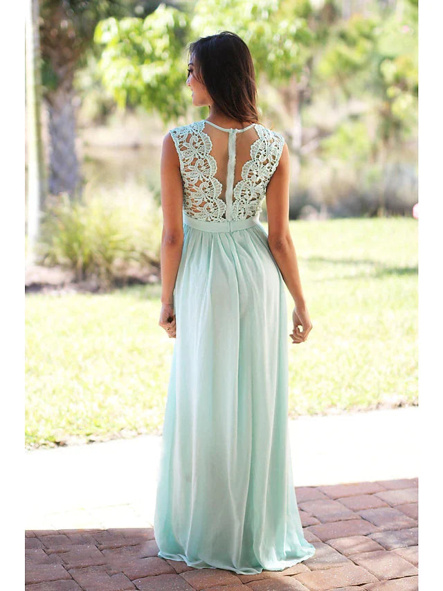 Model wearing a light pink A-line jewel neck floor-length bridesmaid dress with a sash and pleats.