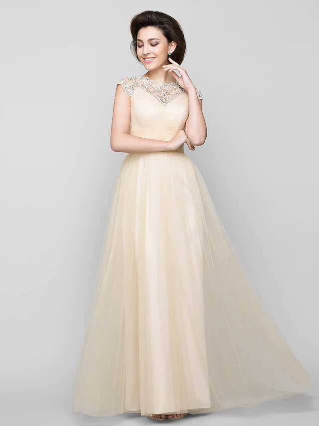 Side profile of woman wearing floor-length beaded Mother of the Bride dress.