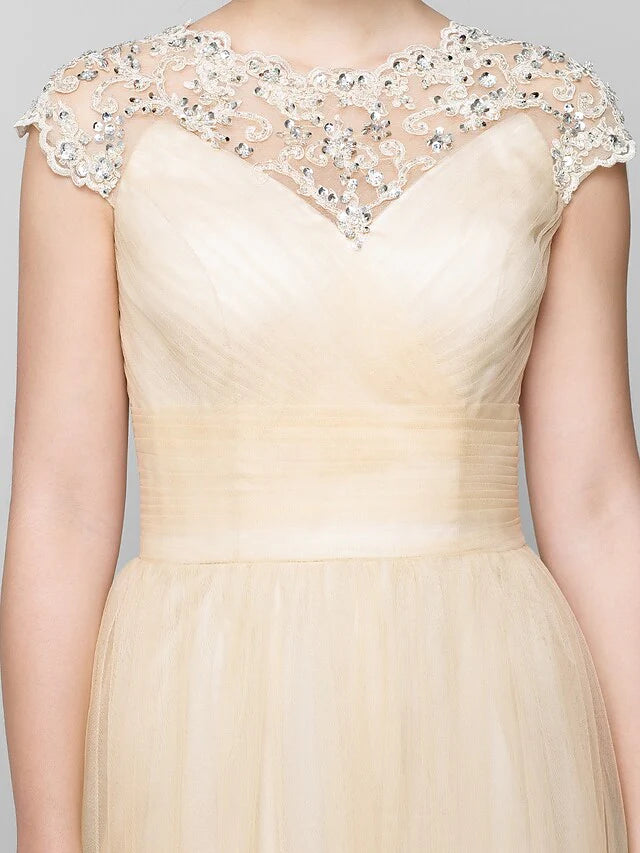 Woman posing in elegant sleeveless A-Line Mother of the Bride gown.