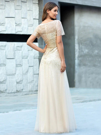 Side view of model wearing A-line tulle sequin bridesmaid gown.