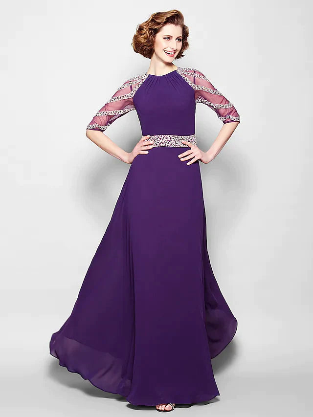Close-up of the jewel neck, half sleeves, and intricate beading on the dress.