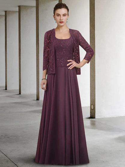 Elegant woman in a blue two-piece A-line Mother of the Bride dress with jewel neck, lace bodice, and pleated chiffon skirt.