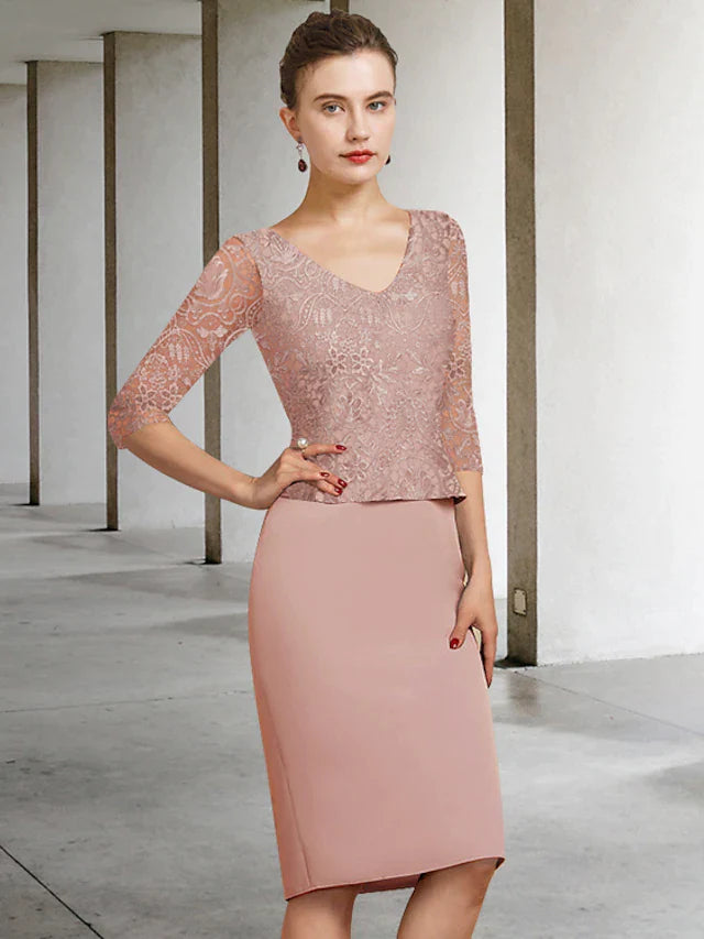 Woman wearing an elegant knee-length Mother of the Bride dress with jewel neck and lace appliques, front view.