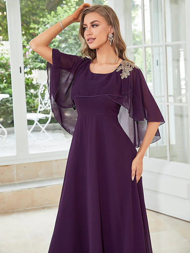Side profile of a woman in a half-sleeve chiffon party dress.