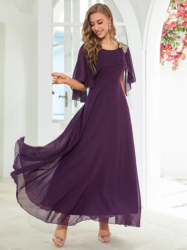Close-up of the jewel neck and ruffled sleeves on an elegant dress.