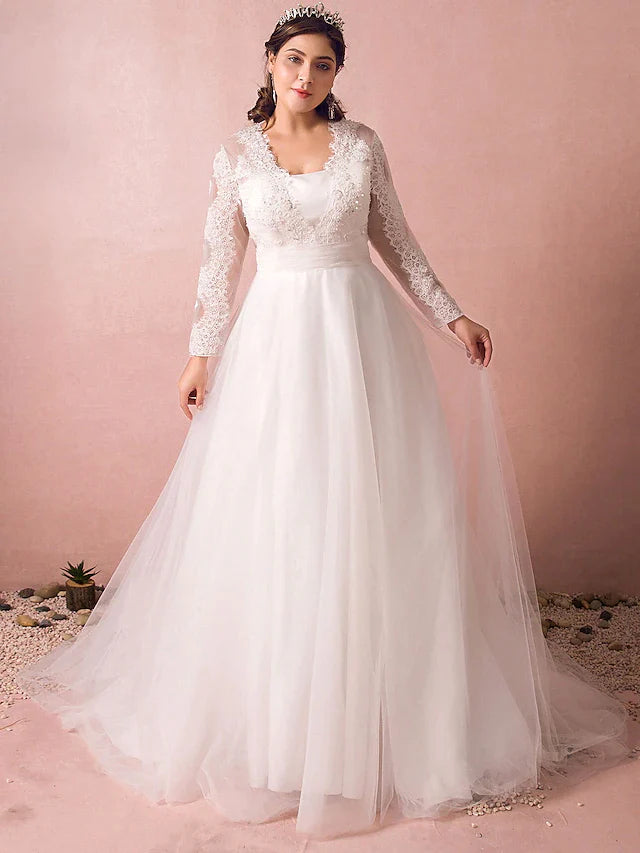 Elegant A-line wedding dress with long lace illusion sleeves and jewel neck.