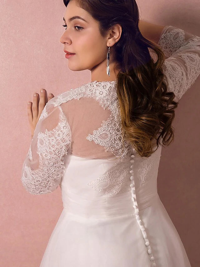 Detailed view of the back of the wedding dress with lace and button closure.