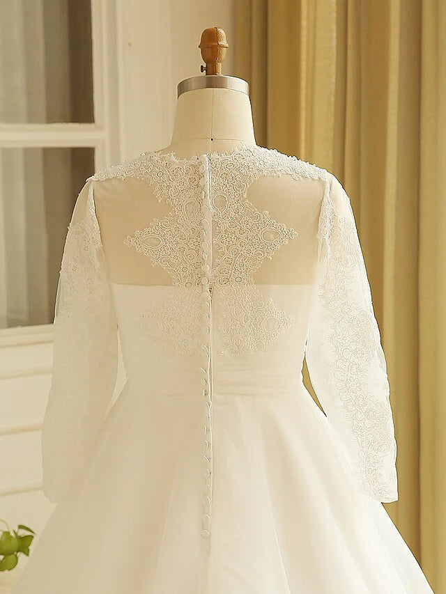 Bride posing in the A-line wedding dress, showcasing the court train.