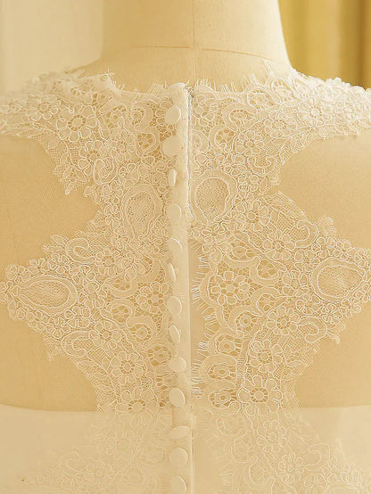 Close-up of the bodice and jewel neck with delicate lace embellishments.