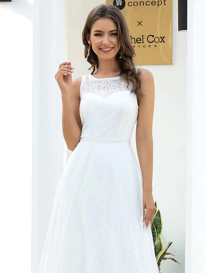 Model posing gracefully in an A-line jewel neck lace tulle wedding dress.