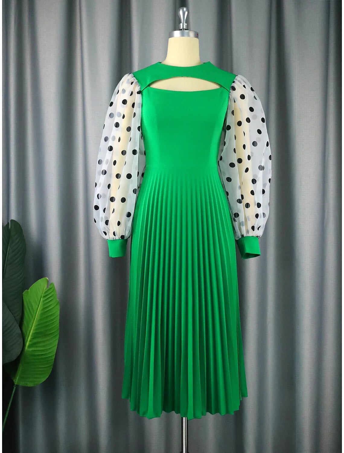 Elegant A-line tea-length chiffon dress with long sleeves and jewel neck, featuring cut-outs and pleats.