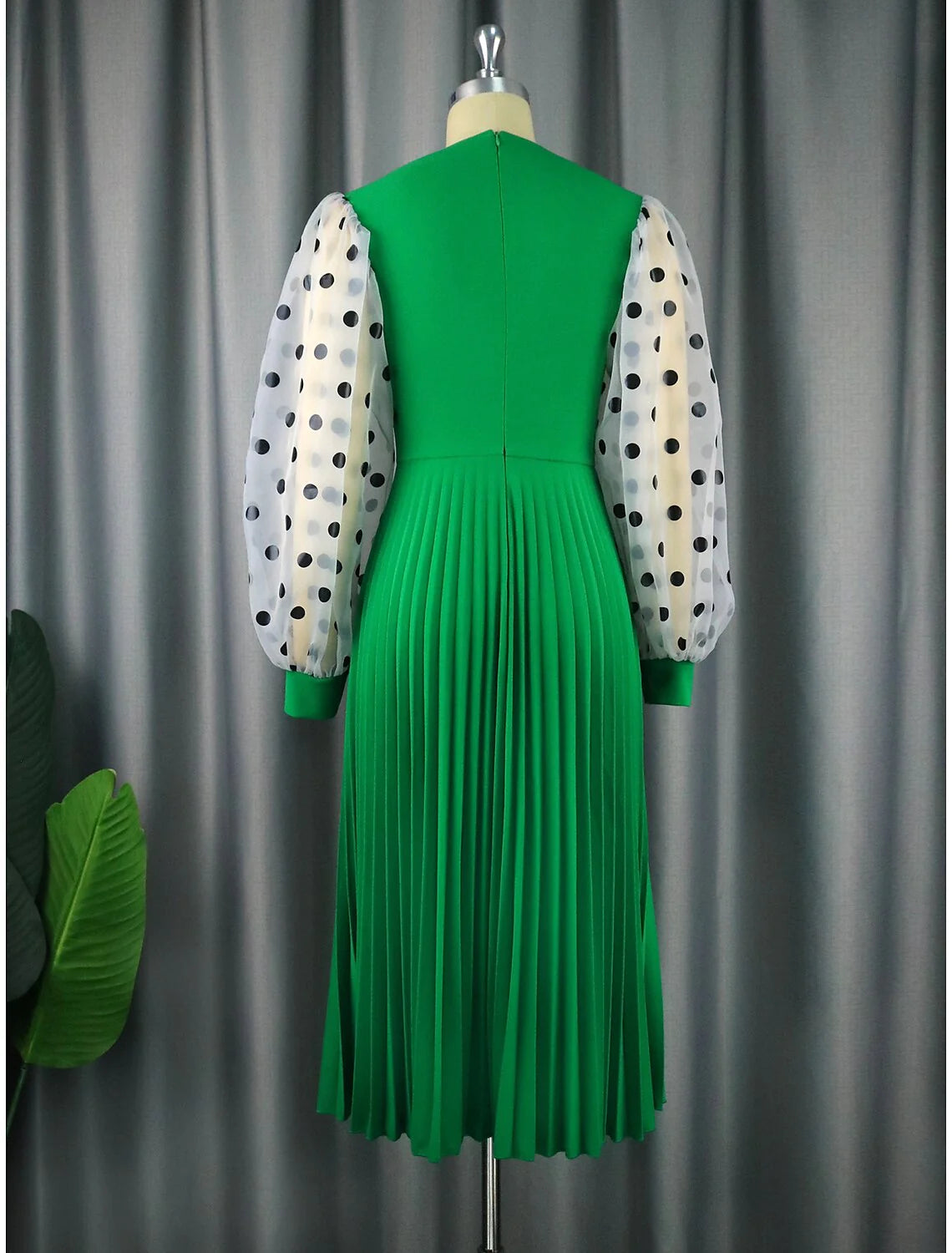 Side view of a sophisticated A-line chiffon party dress with long sleeves and pleated details.