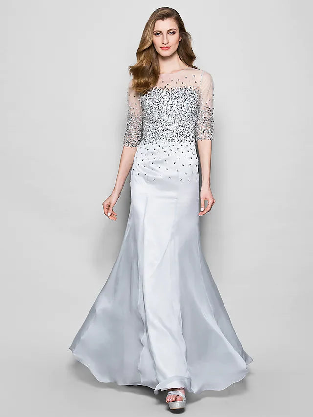 Woman wearing an elegant A-Line Mother of the Bride dress with jewel neck and half sleeves.