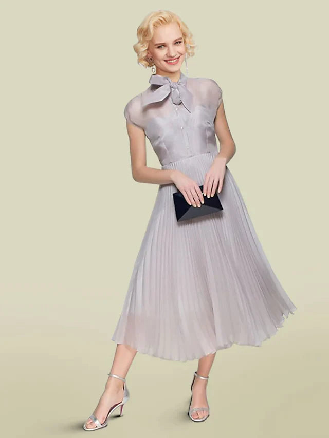 Elegant A-Line Mother of the Bride dress with jewel neck and short sleeves.