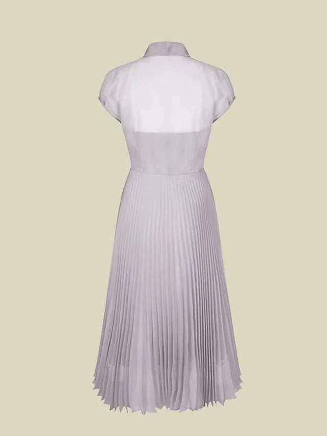 Side view of the tea-length organza dress, highlighting pleats and a bow detail.