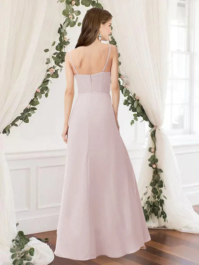 Back view of a pink floor-length bridesmaid dress, highlighting the flowing chiffon fabric and delicate pleats.