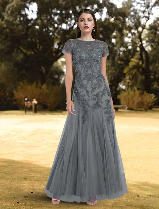 Full-length view of a woman wearing an elegant A-line jewel neck short sleeve lace pleated floor-length evening gown.