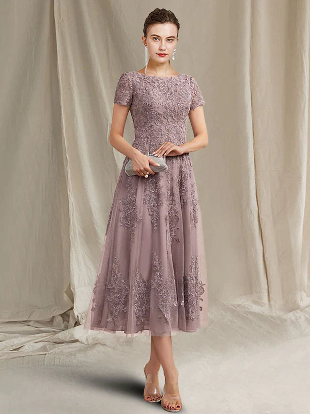 Elegant A-line mother of the bride dress with jewel neck and short sleeves.