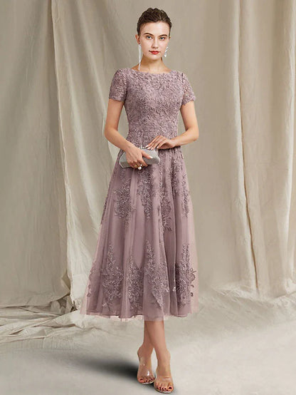 Elegant A-line mother of the bride dress with jewel neck and short sleeves.