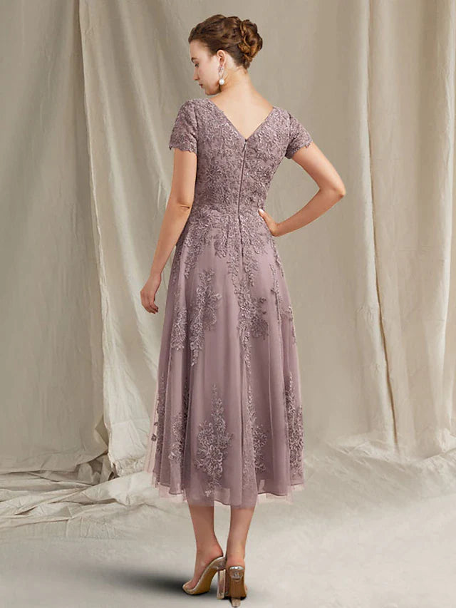 Back view of the tea length lace tulle dress with appliques.
