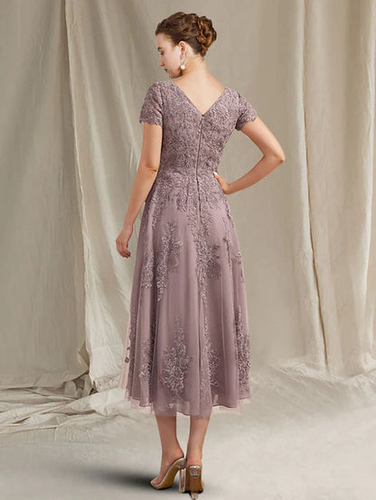 Back view of the tea length lace tulle dress with appliques.