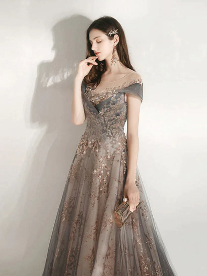 Close-up of jewel neck and short sleeve on a tulle bridesmaid dress.
