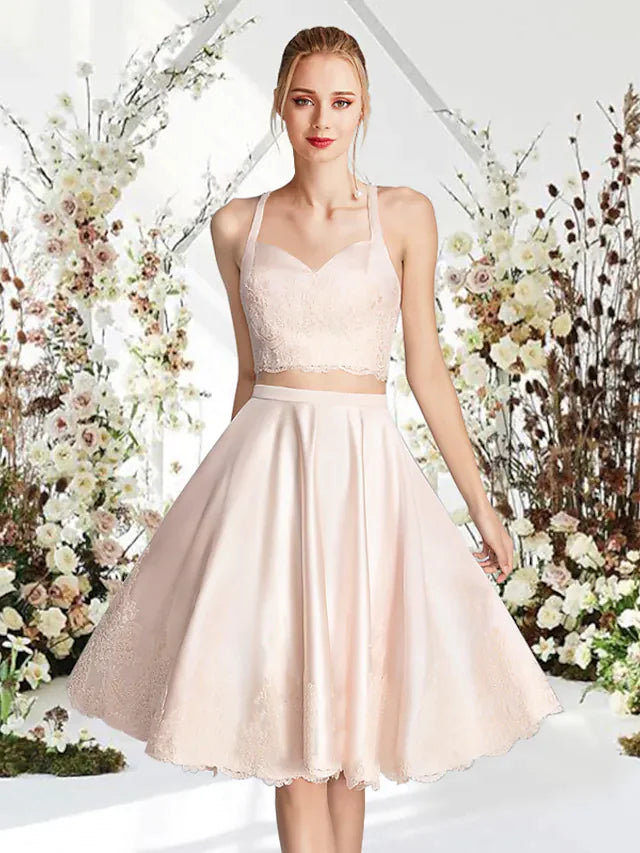 Model wearing an A-line jewel neck sleeveless mini cocktail dress made of lace and satin.