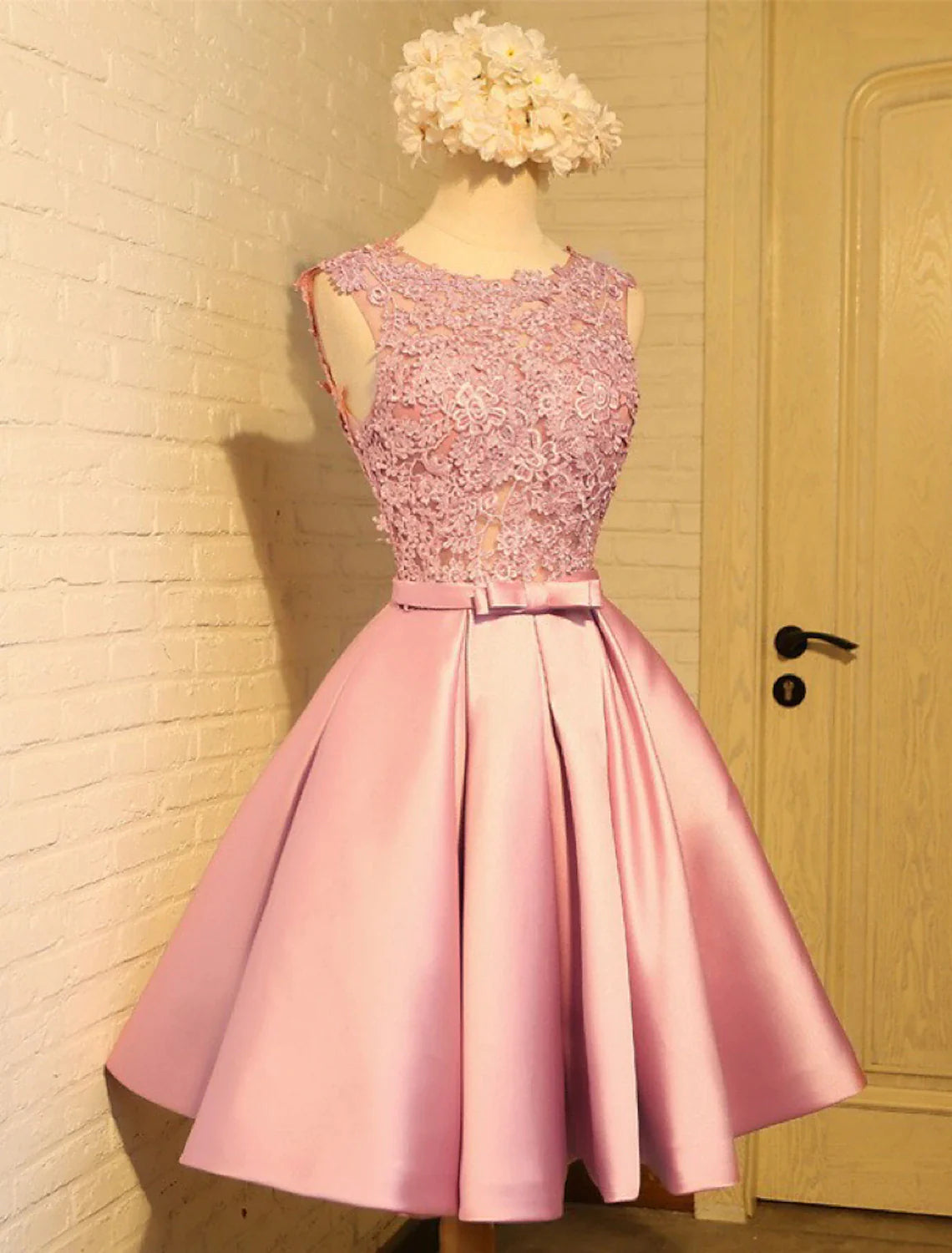 Model wearing an elegant A-Line lace homecoming dress with an open back.