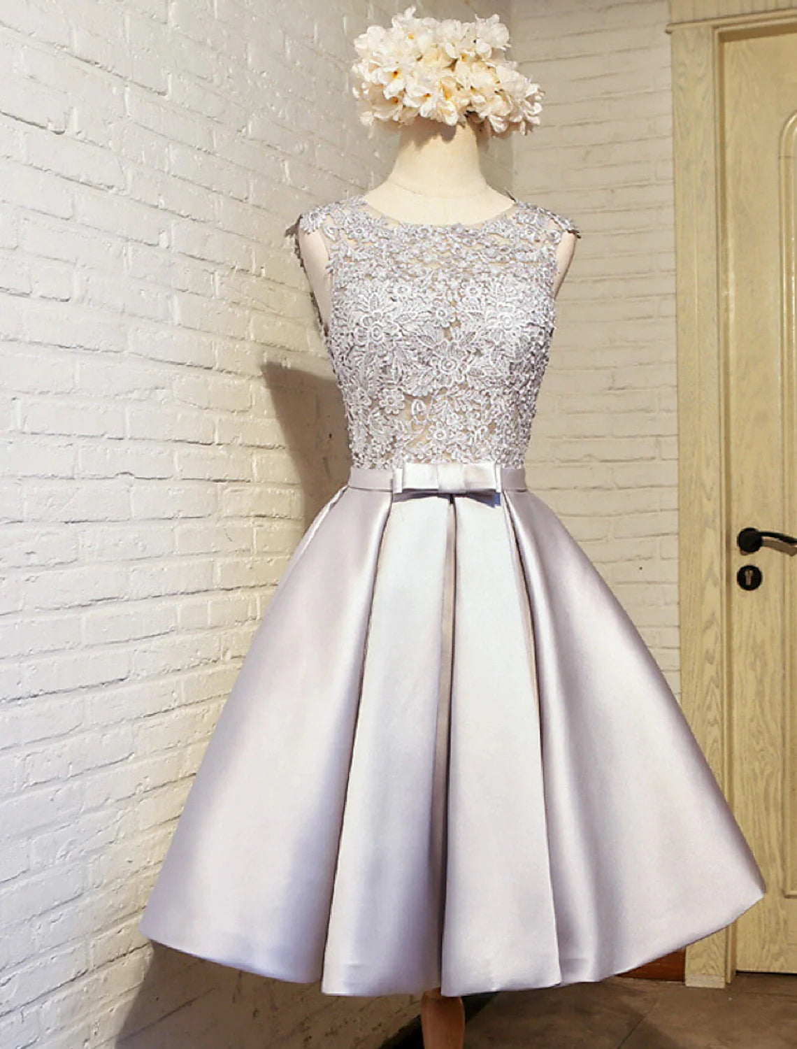 Front view of the A-Line lace jewel neck dress on a model.