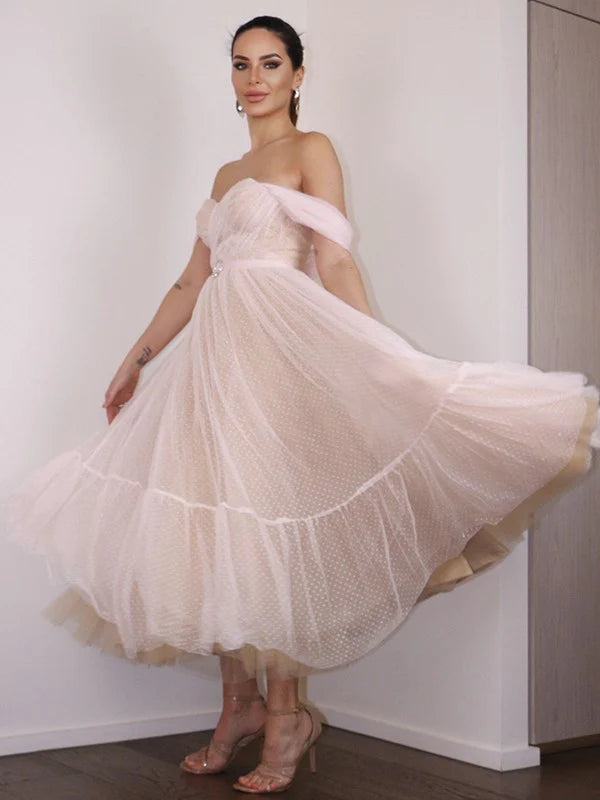 Back view of an A-line ruched off-shoulder prom dress.